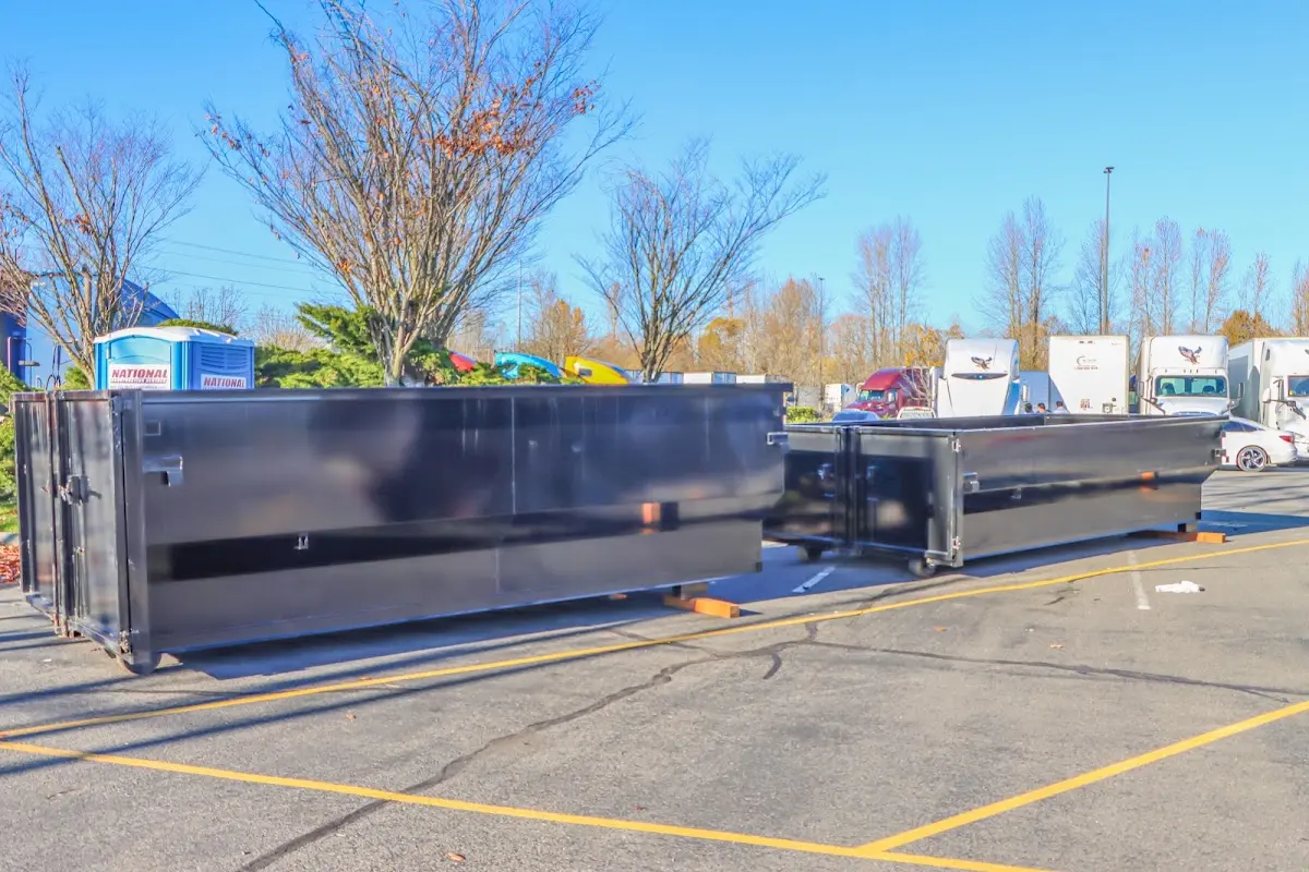 Professional dumpster rental service with roll-off container on residential driveway in North Auburn